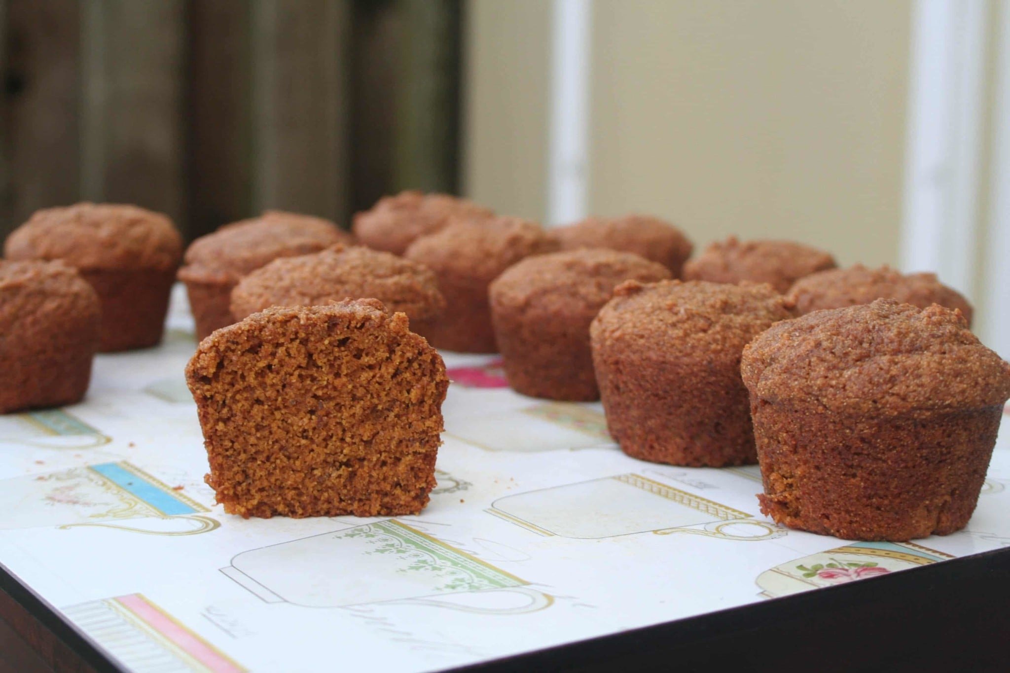 Delicious Pumpkin Molasses Mini Muffins on a cooling rack, garnished with a sprinkle of sugar.