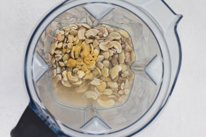 making cashew mayo for vegan potato salad, cashews and ingredients in a blender.