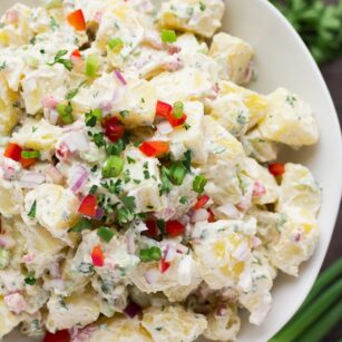 close up of vegan potato salad in white bowl