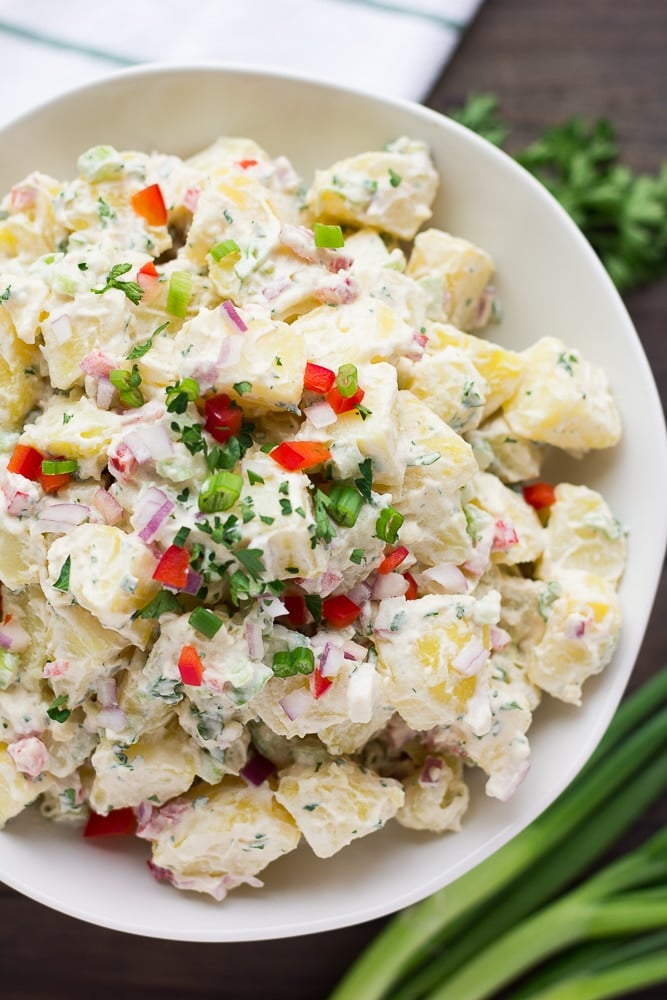 close up of vegan potato salad in white bowl