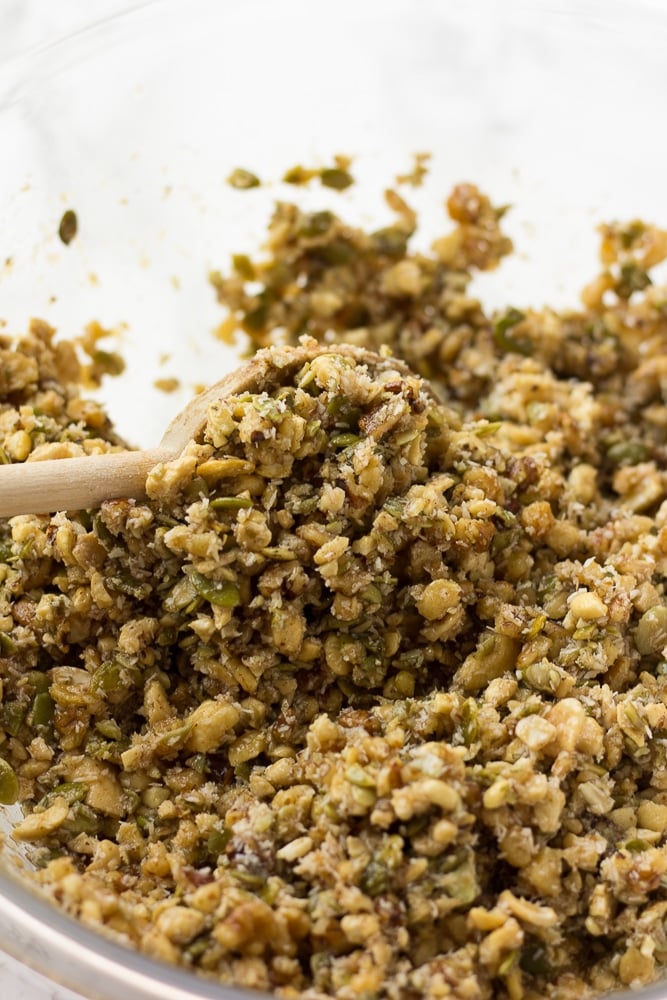 grain free granola before baking being mixed in a bowl