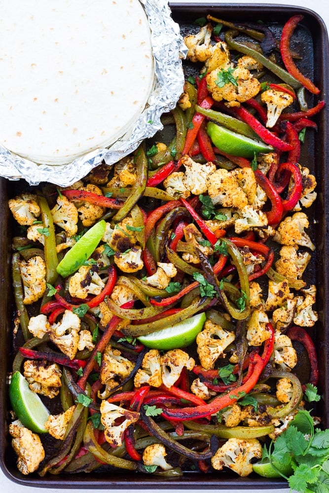 cooked vegetarian fajitas in pan with tortillas.