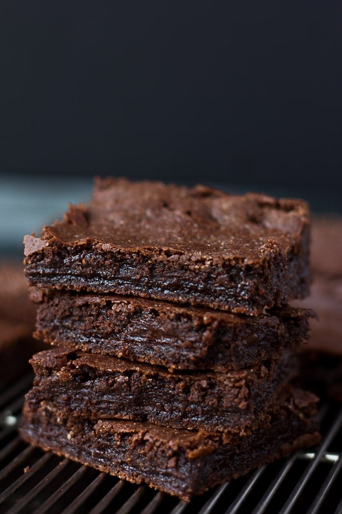 Stack of vegan brownies with black background.