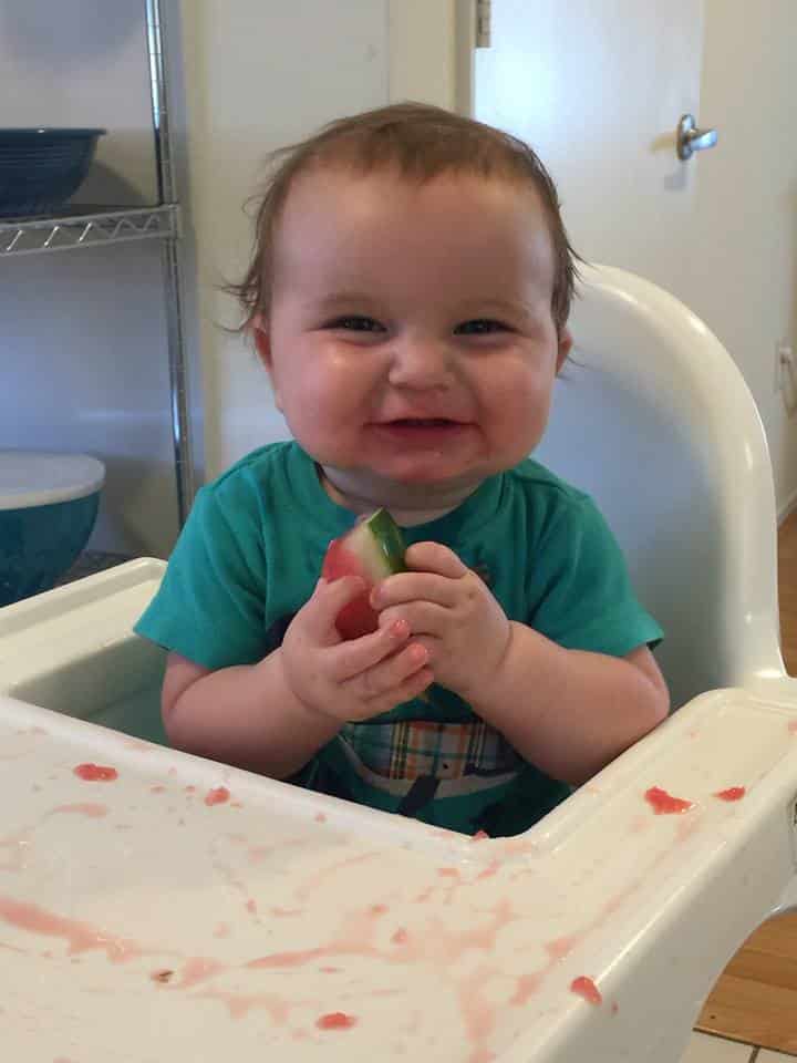 baby holding watermelon