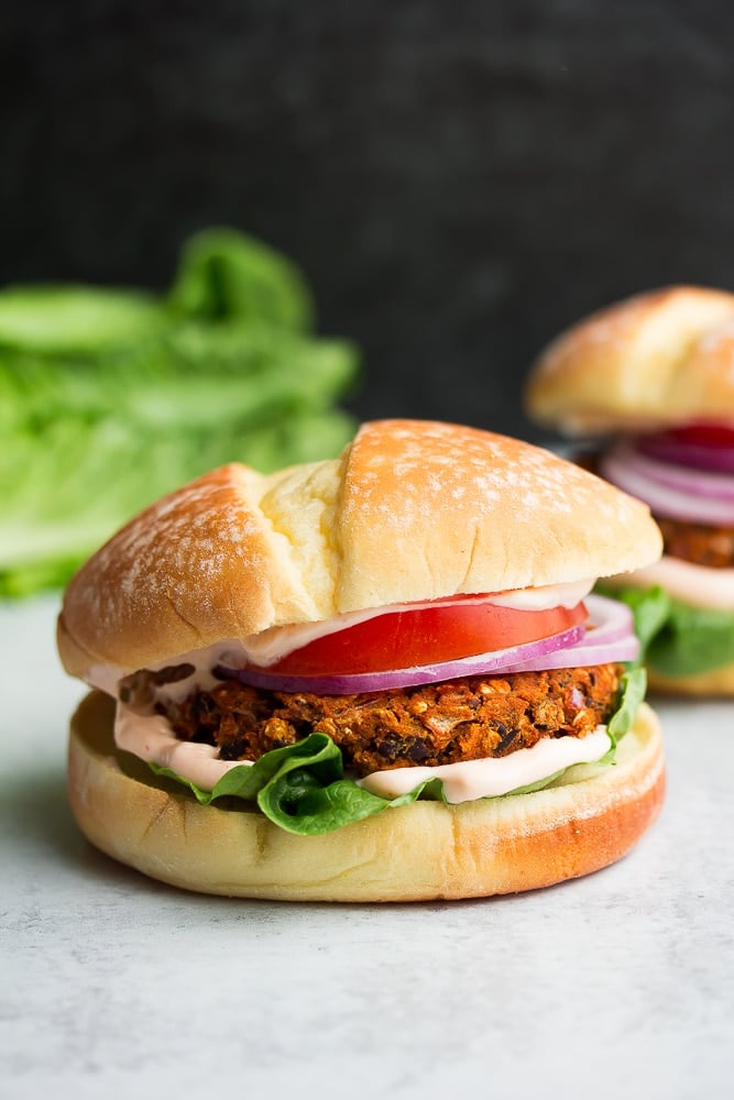 burger with orange/bean patty, tomato, onion, mayo and lettuce