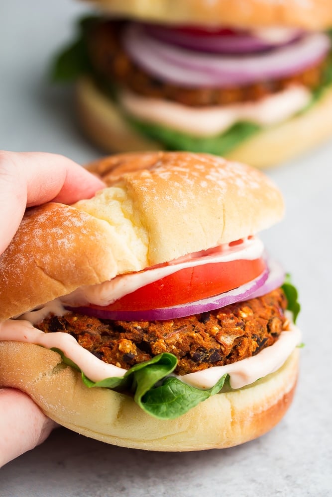 hand grabbing a burger (not meat)