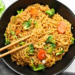 square image of a black bowl filled with Asian noodles