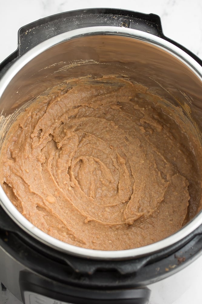 instant pot pan full of smooth refried beans.