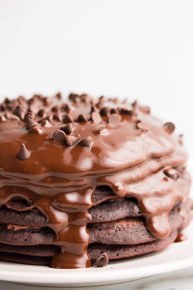 stack of chocolate pancakes with ganache and chocolate chips