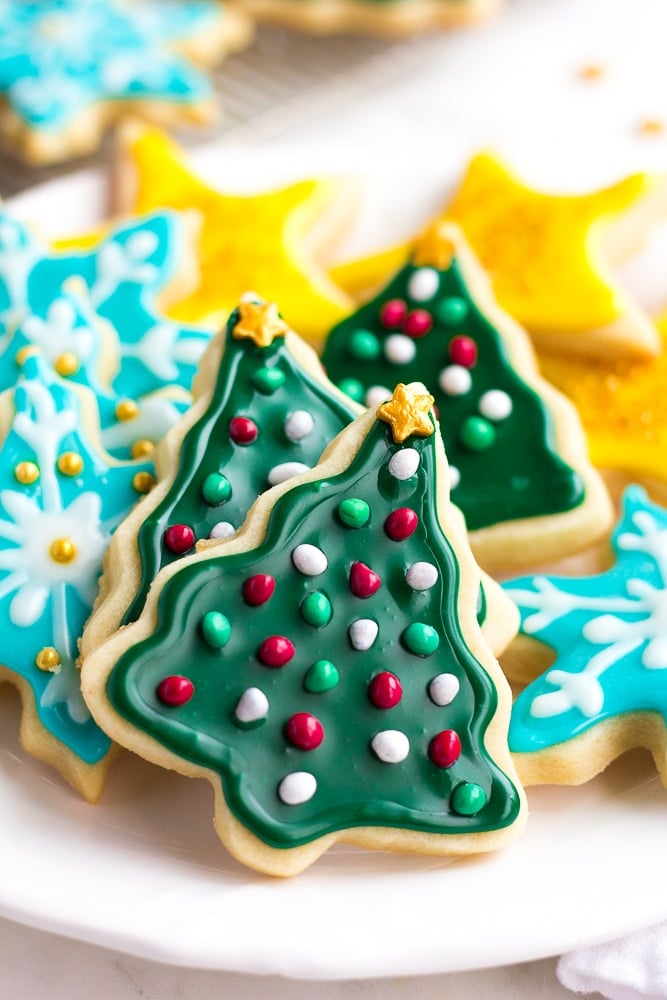 frosted vegan sugar cookies in stacks on a plate