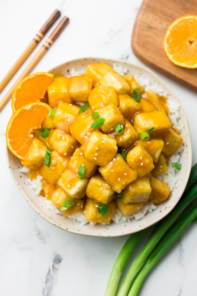 orange tofu on top of rice