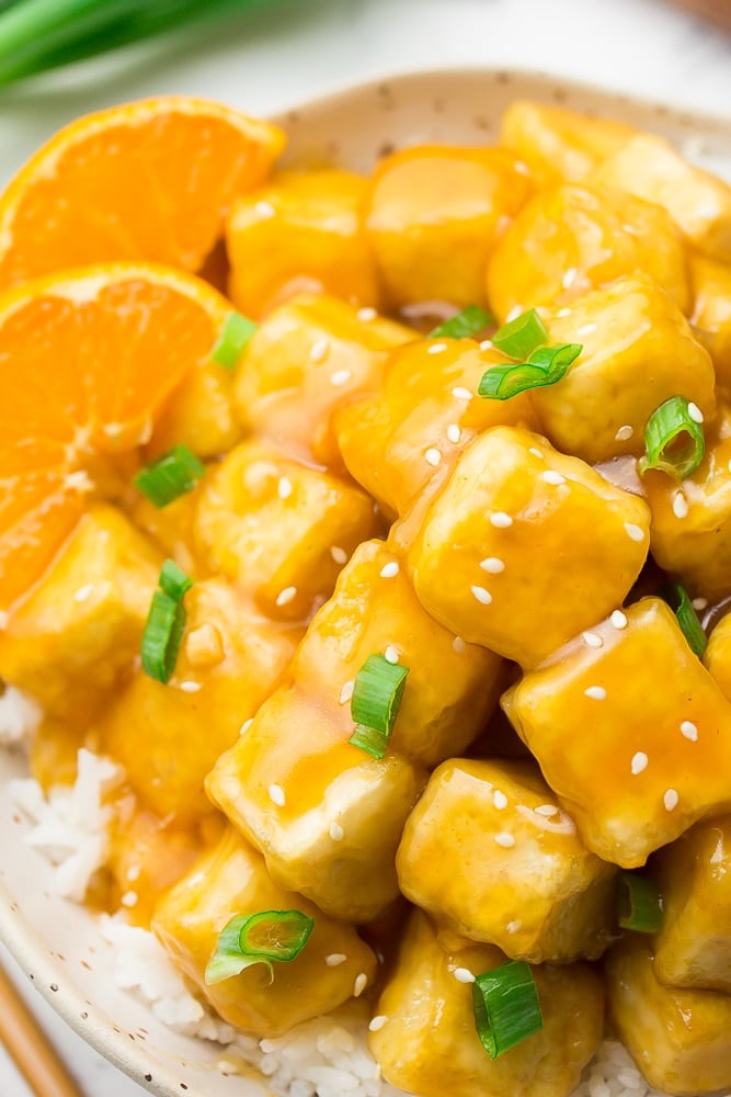 very close up shot of orange tofu