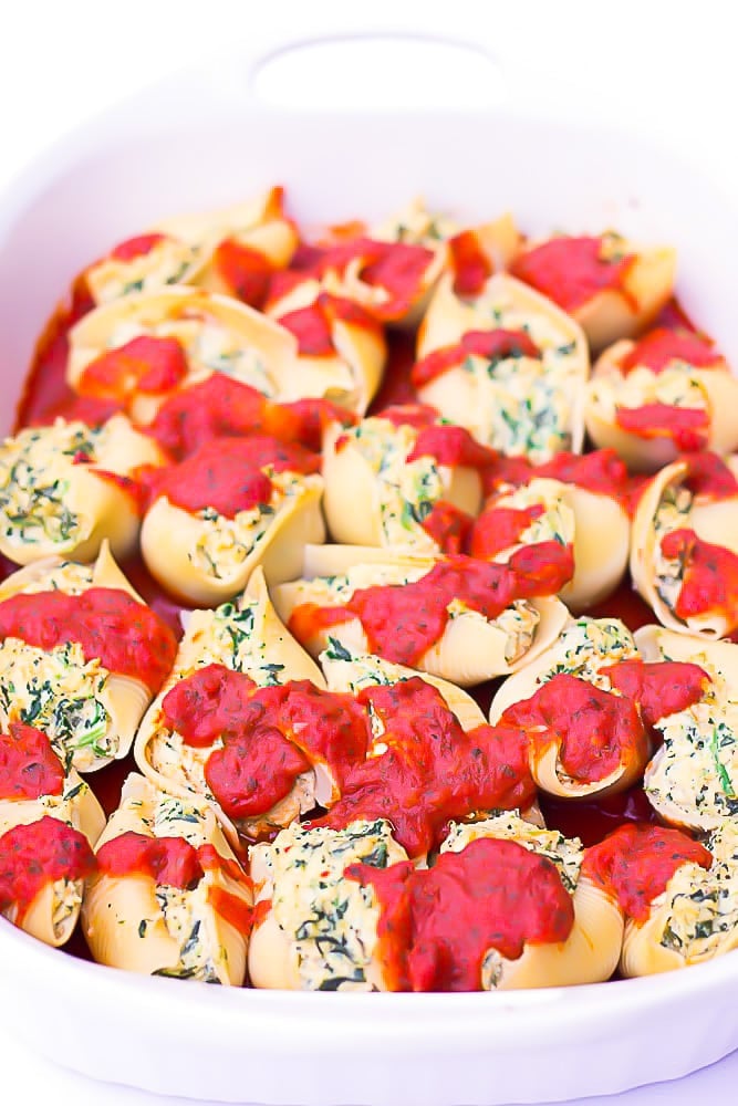 side shot of a casserole dish full of shells with marinara