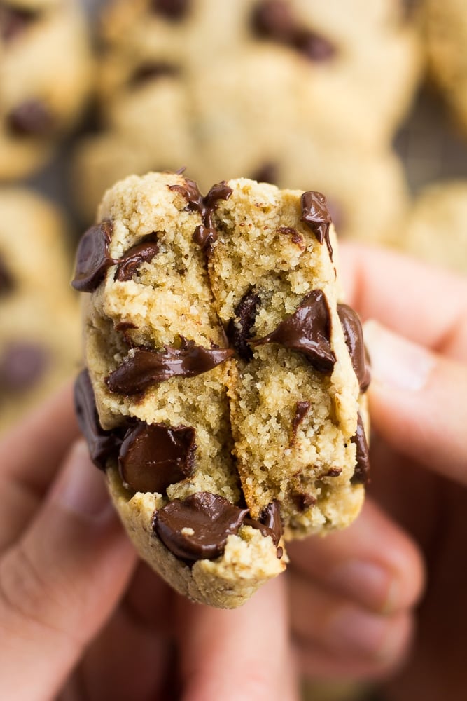vegan gluten free chocolate chip cookies, broken in half to show texture inside.