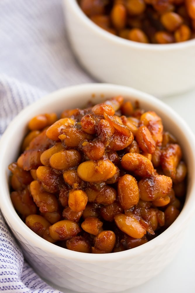 side shot of baked beans in white bowls