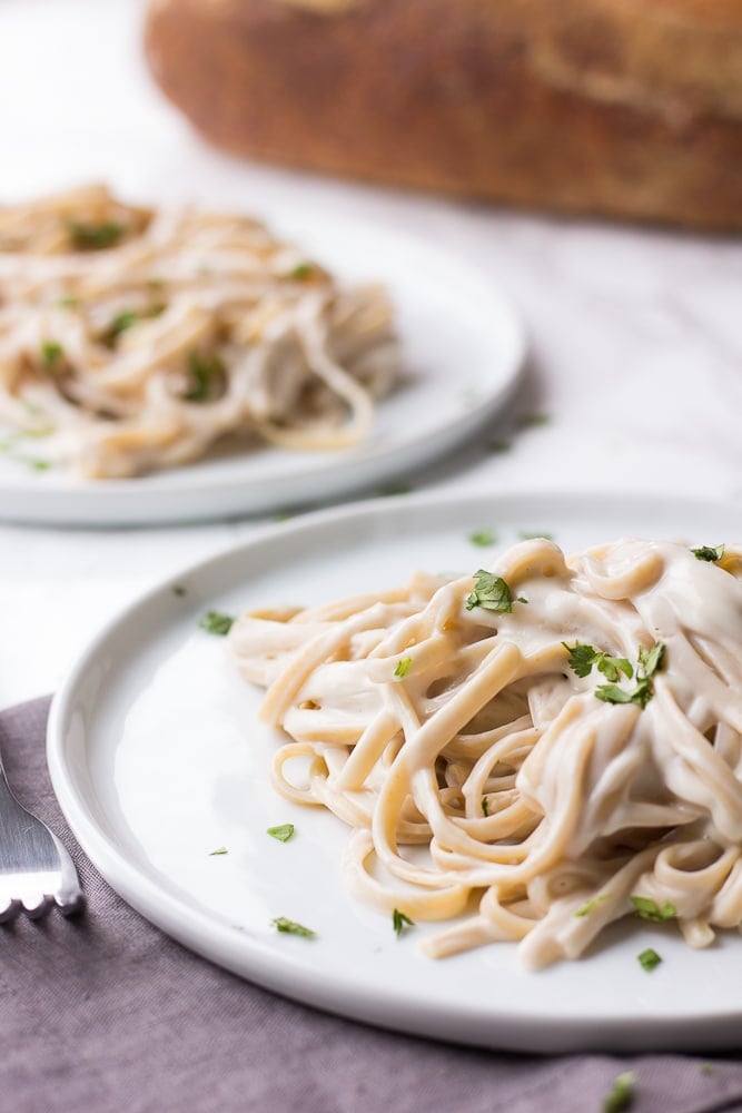 vegan alfredo with fettucine on two plates