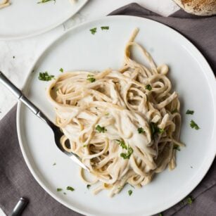 vegan alfredo fettucine on two plates