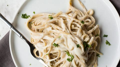 vegan alfredo fettucine on two plates
