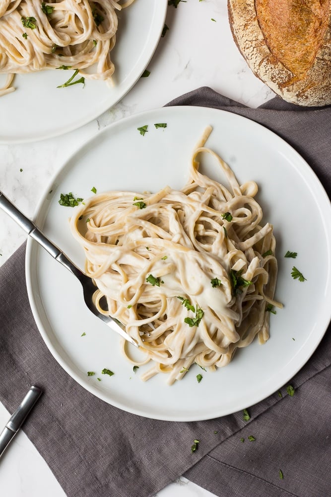 vegan alfredo fettucine on two plates