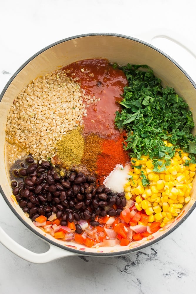 white pot with beans, rice, corn, salsa and more
