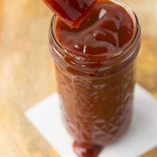 Quick and Easy Vegan Barbecue Sauce in a mason jar with a brush.