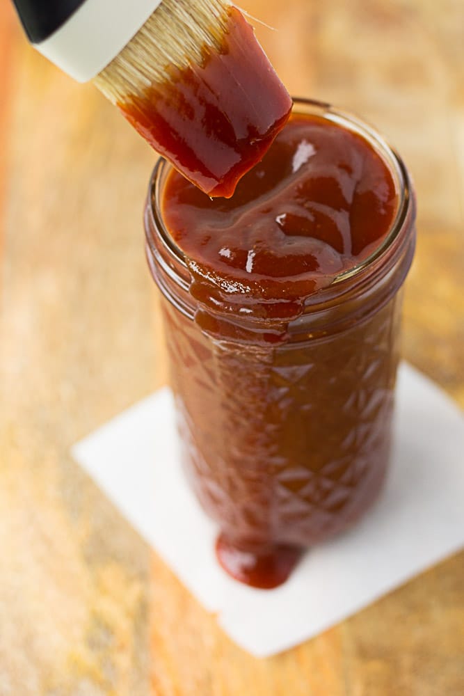 Quick and Easy Vegan Barbecue Sauce in a mason jar with a brush.