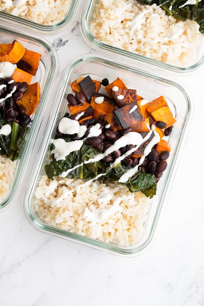 close up of a container with meal prep - rice, beans, potatoes, etc.