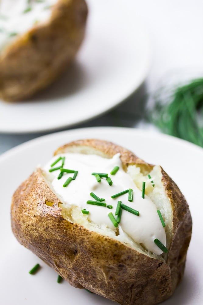 baked potato filled with vegan sour cream and chives