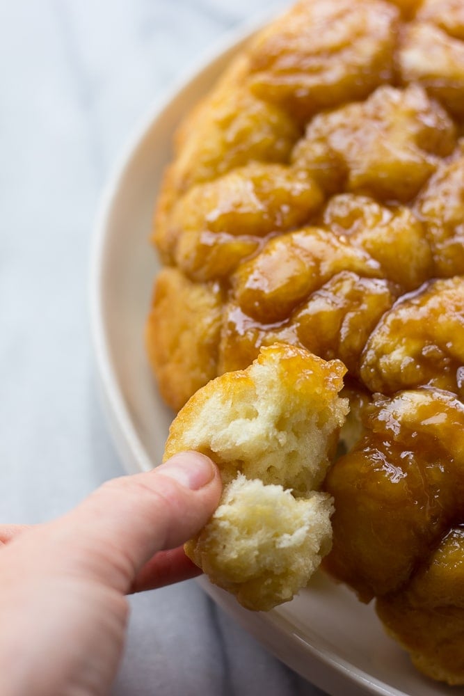 taking a piece off of caramel monkey bread with fingers