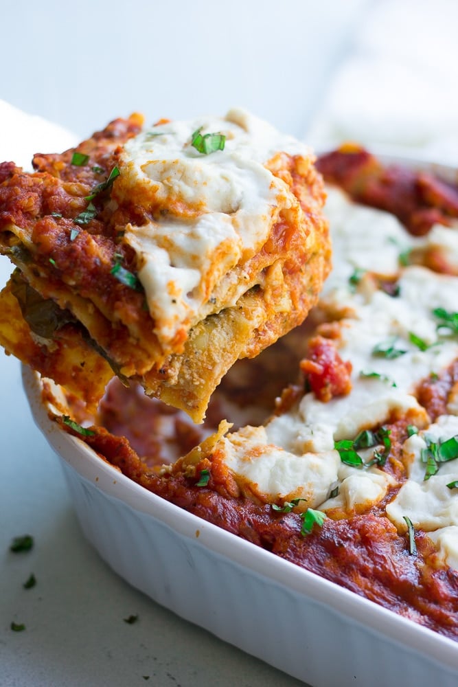 vegan lasagna being picked up from the pan.