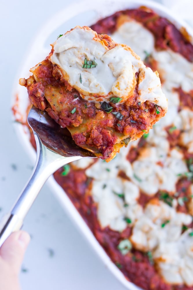 vegan lasagna, from above, on a spatula to serve.