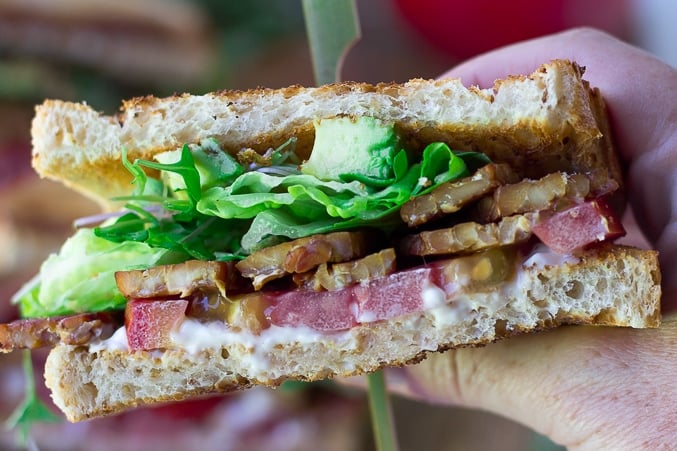 vegan blt being held up close