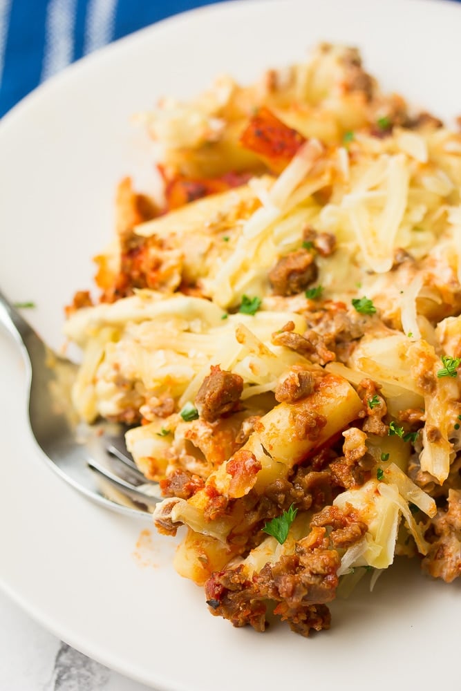 close up of vegan baked ziti on plate with a fork