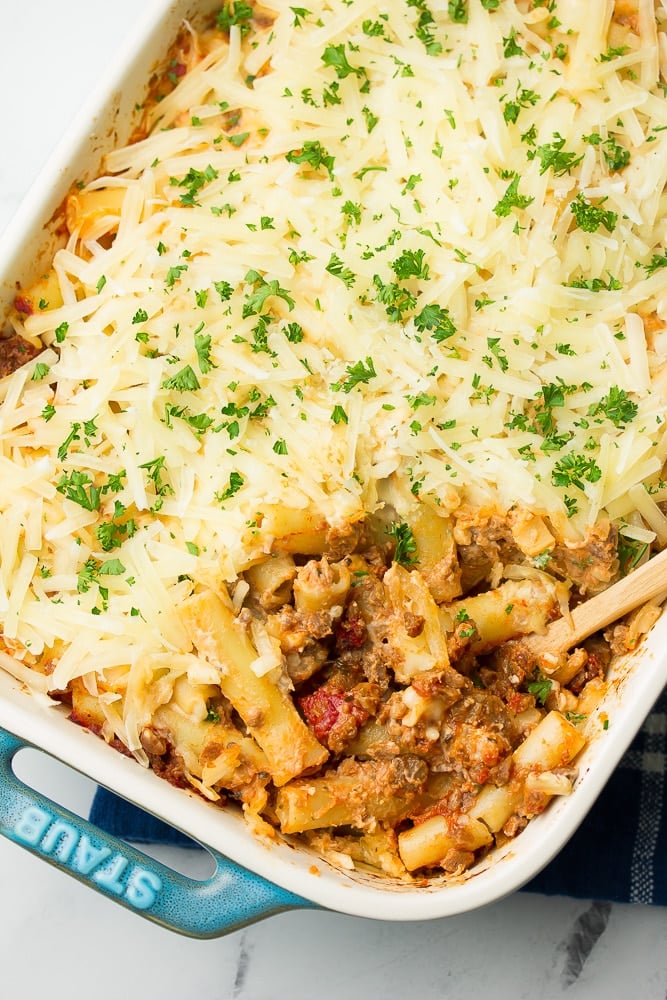 casserole dish of vegan baked ziti with spoon in it.
