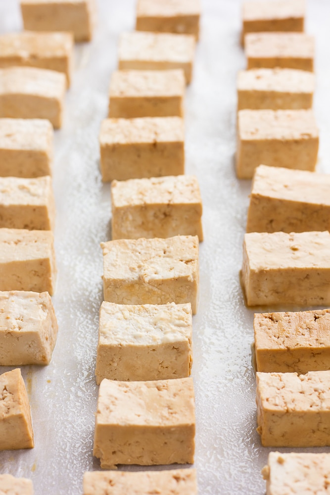 tofu ready to go in oven on parchment paper