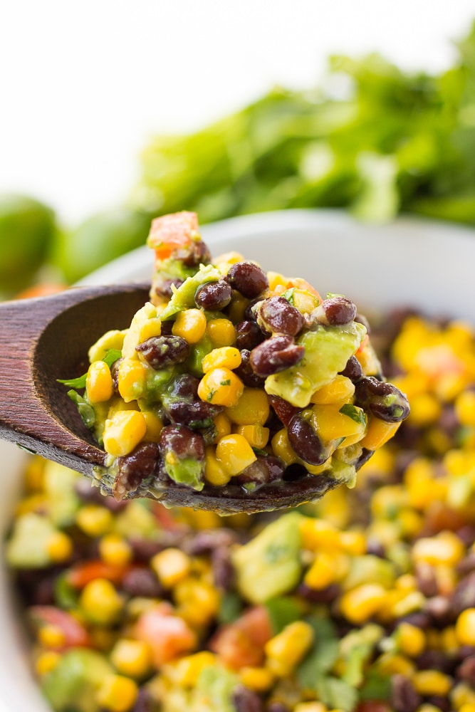 black bean corn avocado salad on a spoon close up