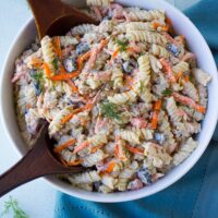 bacon ranch vegan pasta salad in a bowl with wood spoons