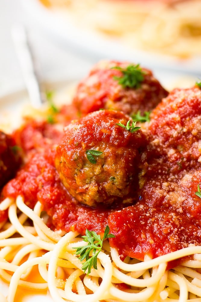 close up of a ball with marinara on spaghetti