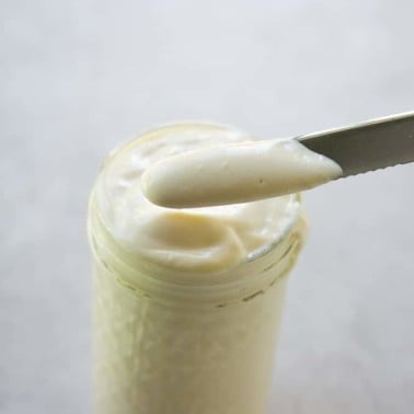 tofu mayonnaise in a jar and on a knife