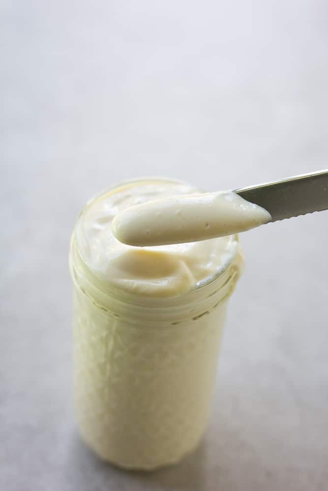 tofu mayonnaise in a jar and on a knife