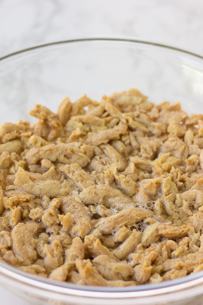 soy curls being soaked in a bowl