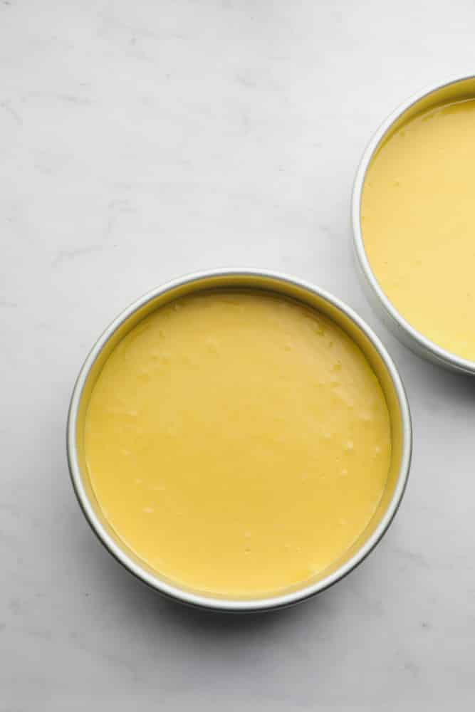 yellow cake batter in two pans