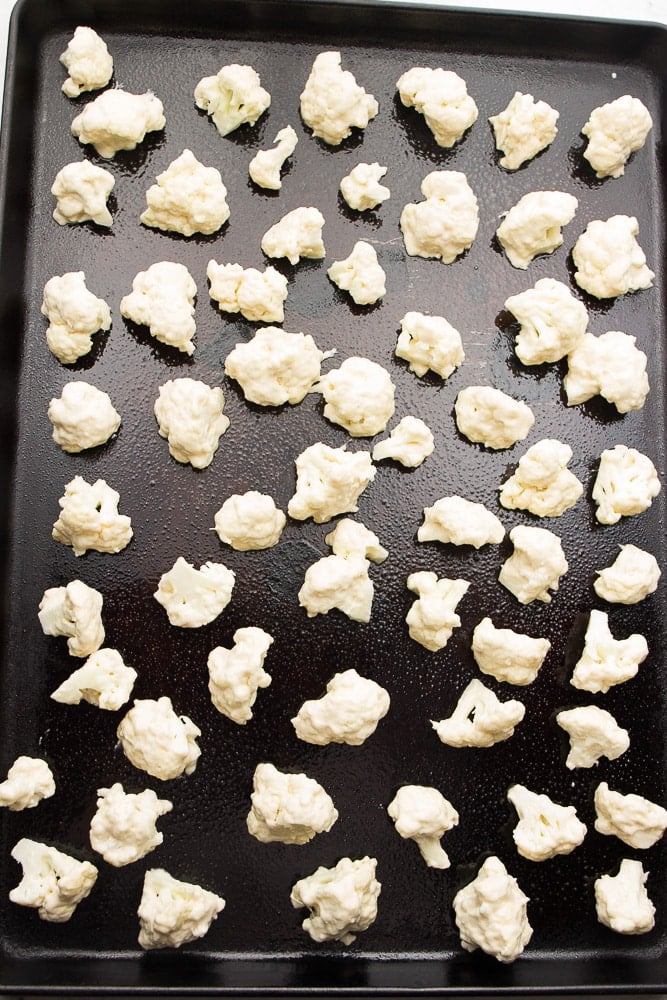 battered cauliflower ready to roast on pan