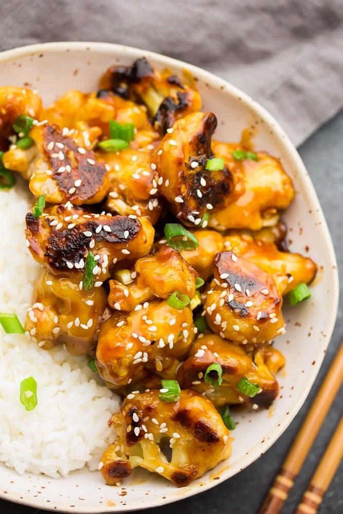 close up of a bowl with white rice and sticky cauliflower