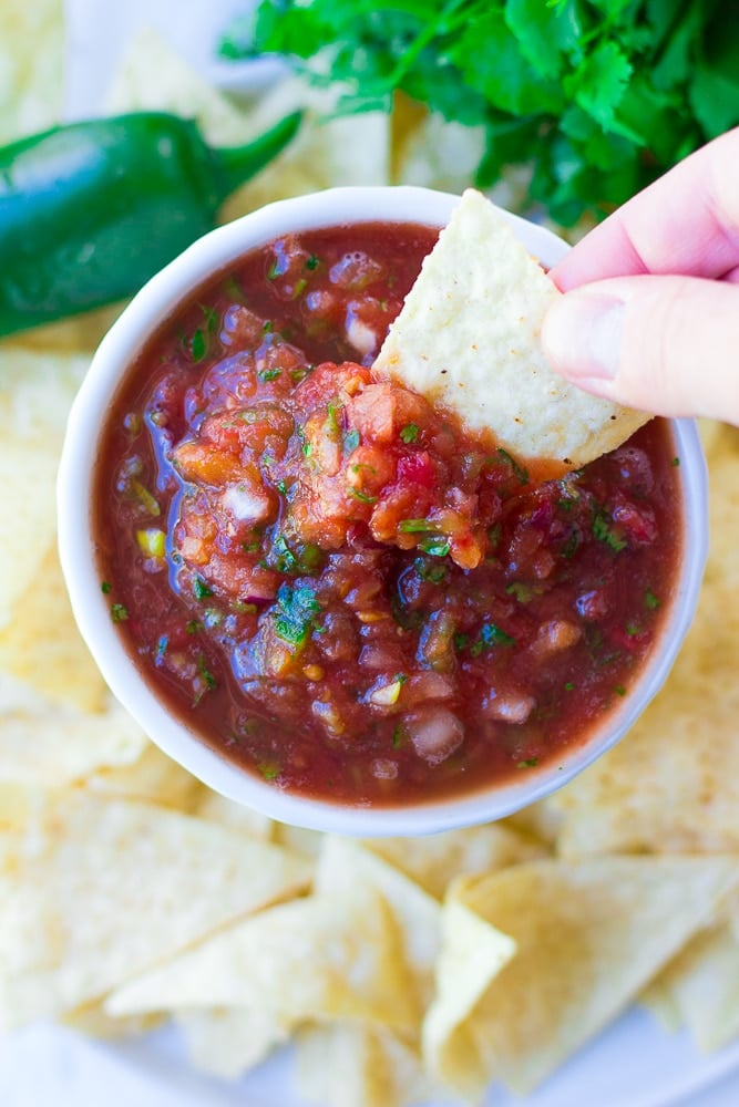 chip dipping into restaurant style salsa recipe