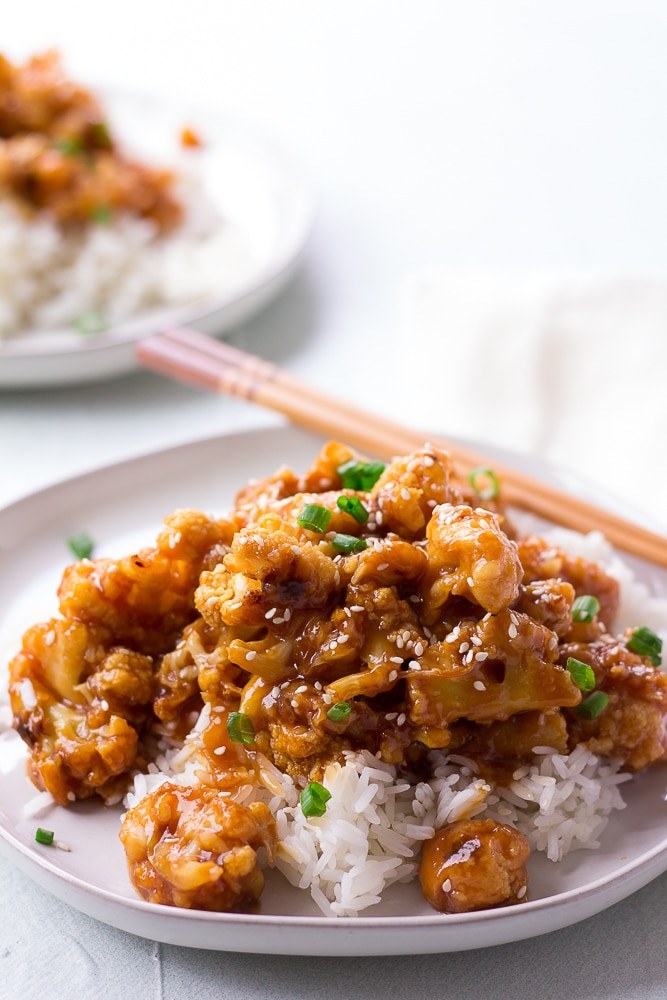 sesame cauliflower on a plate with chopsticks