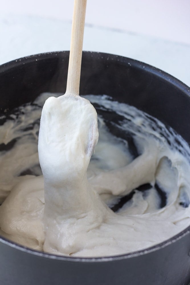 stretchy vegan mozzarella on a spoon in a pan