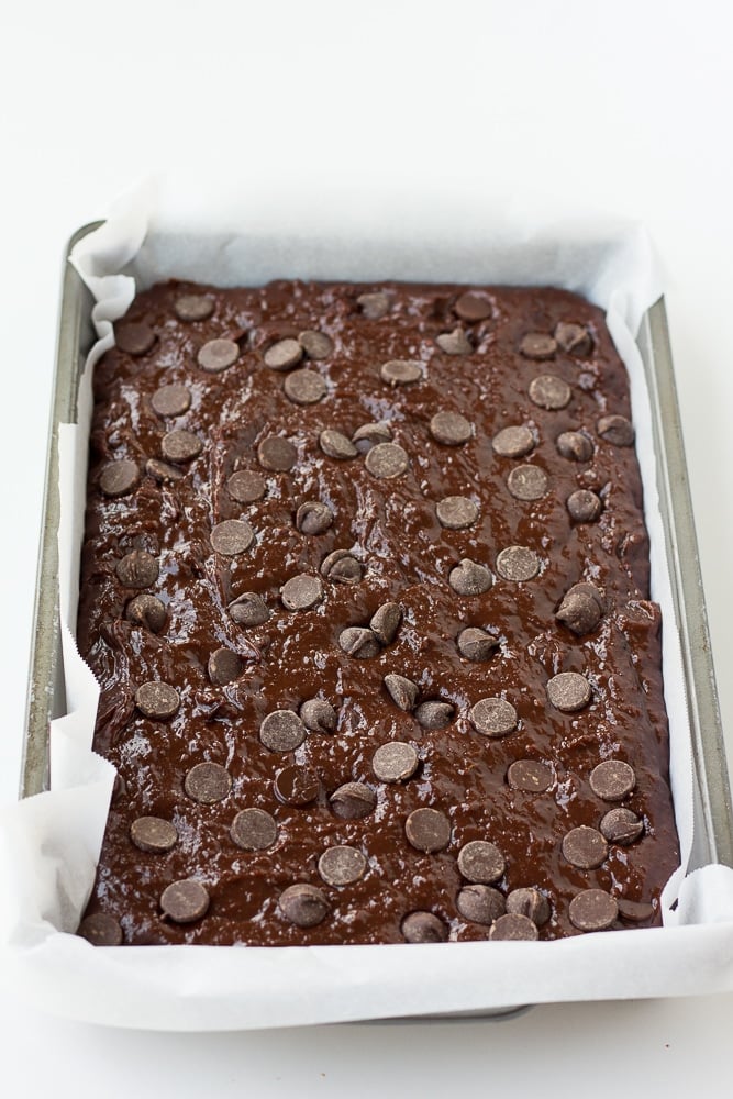 vegan brownies batter in pan with parchment paper