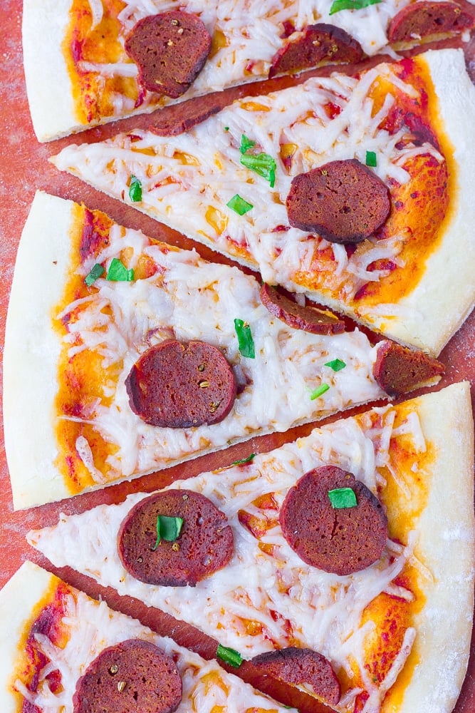 slices of vegan pepperoni pizza on a cutting board