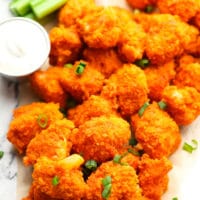 a bunch of cauliflower with hot sauce on a white background